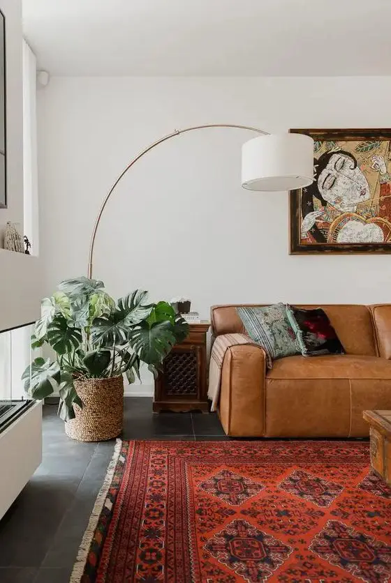 A bright boho living room with a low tan leather sofa