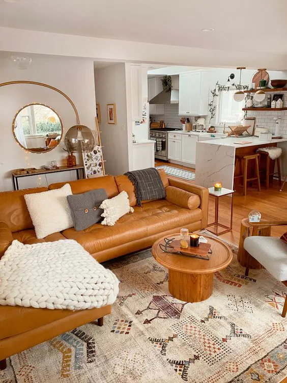 A cozy modern living room with a tan leather sofa